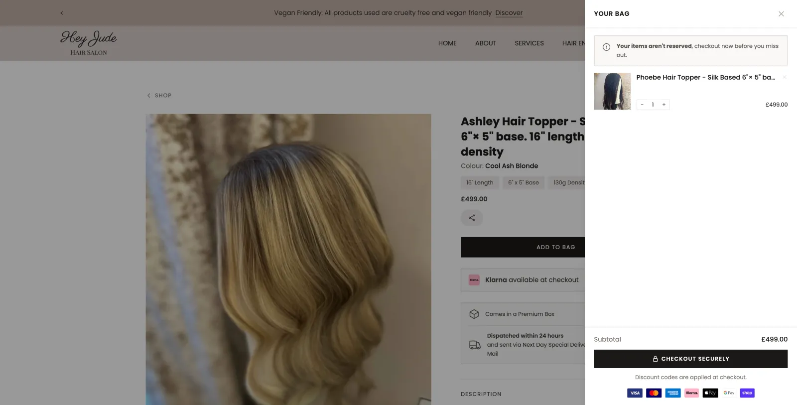 Cart drawer open on desktop showing the Phoebe Hair Topper added to the bag with subtotal and checkout button